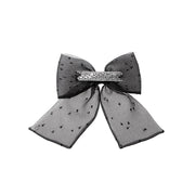 Willa - Noeud fait en organza noir avec des plumetis argentés et des strass.