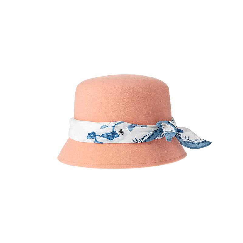 Cloche hat in peach felt with flowers on a printed scarf all around the hat